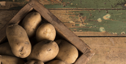 potatoes in crate on table