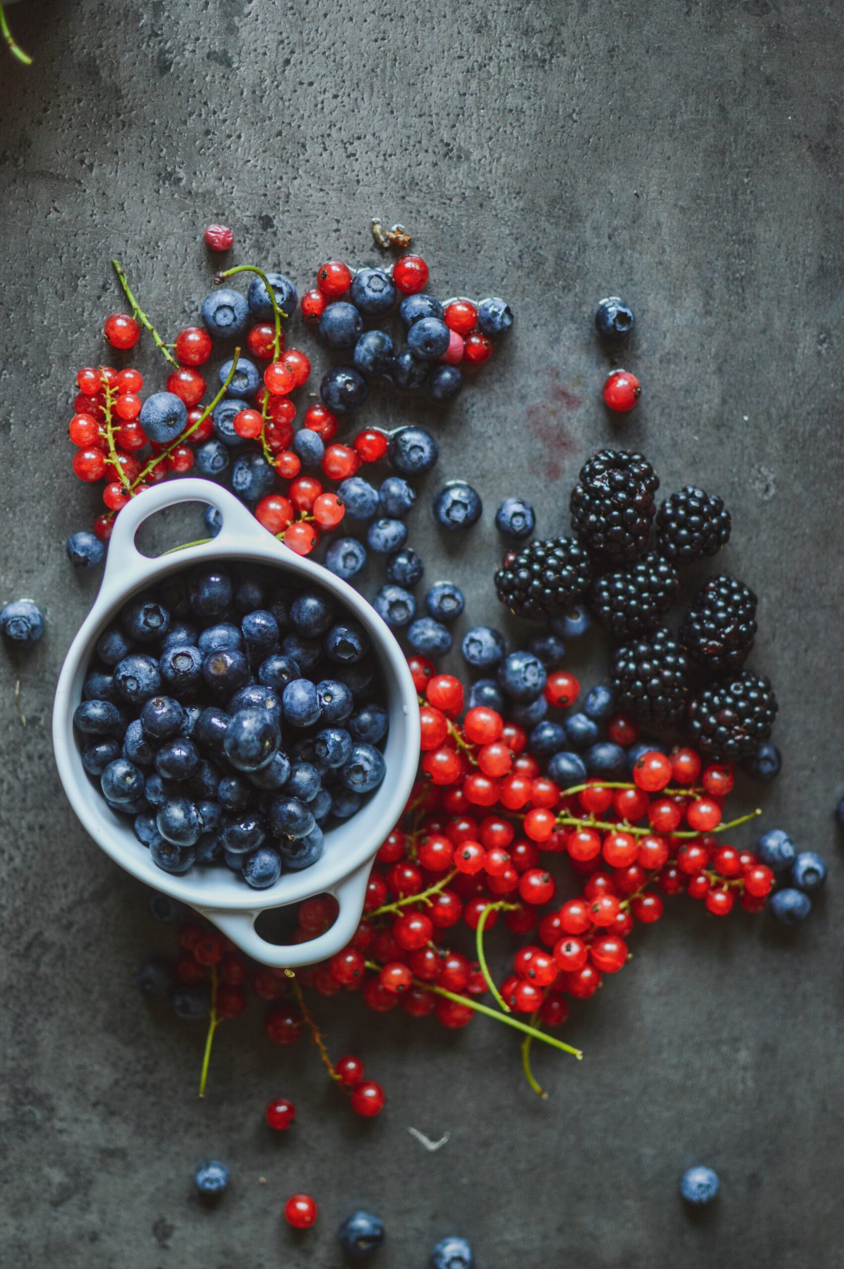 berries on counter and in white bowl