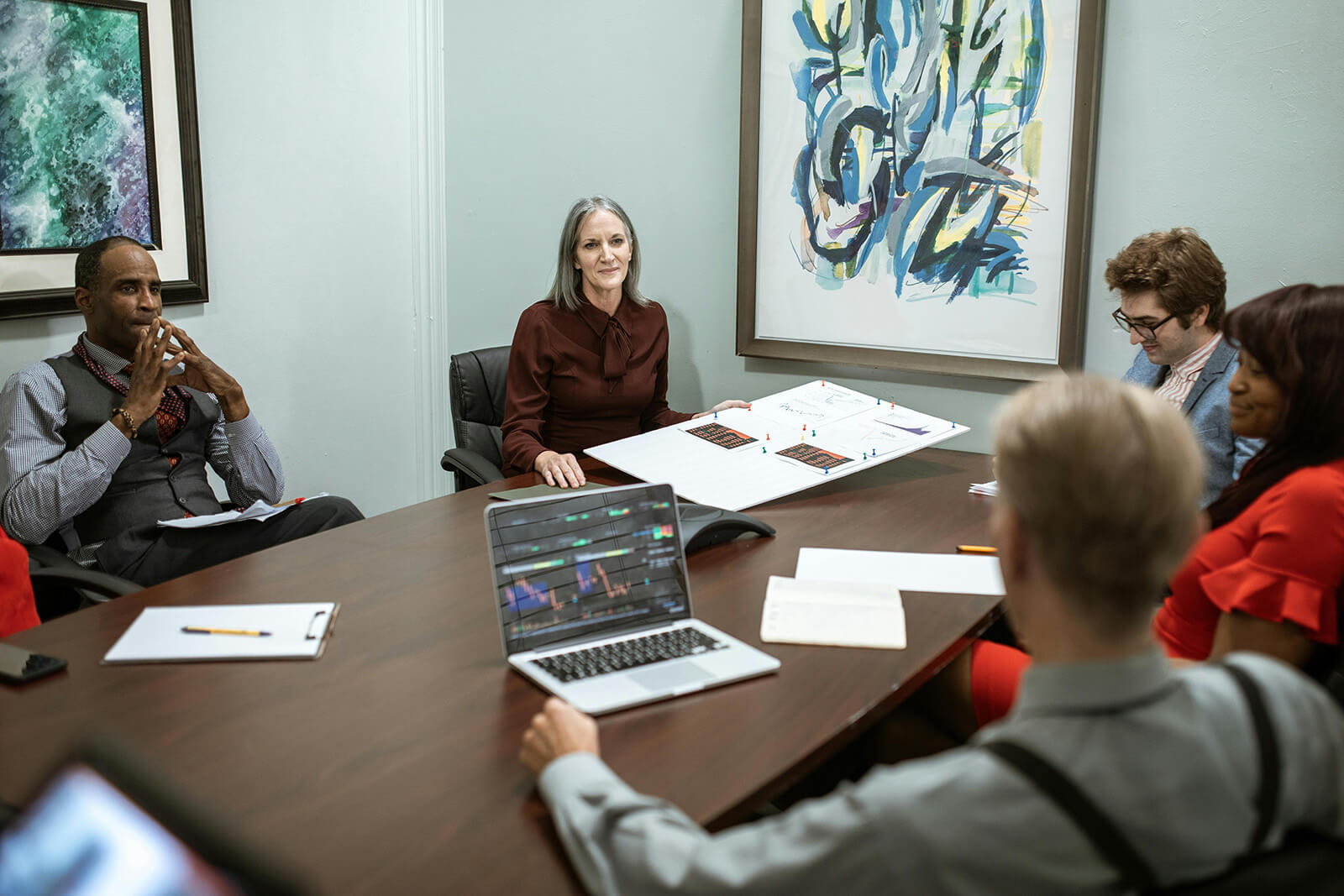 office members discussing plans with plan board