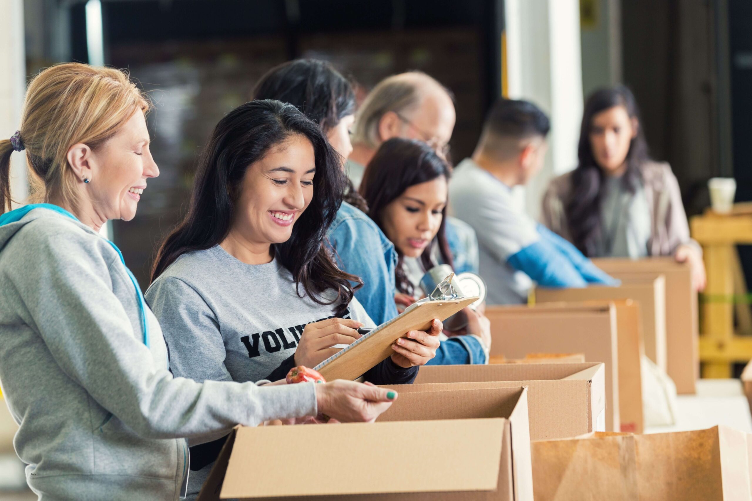 food bank volunteers taking inventory in front of boxes