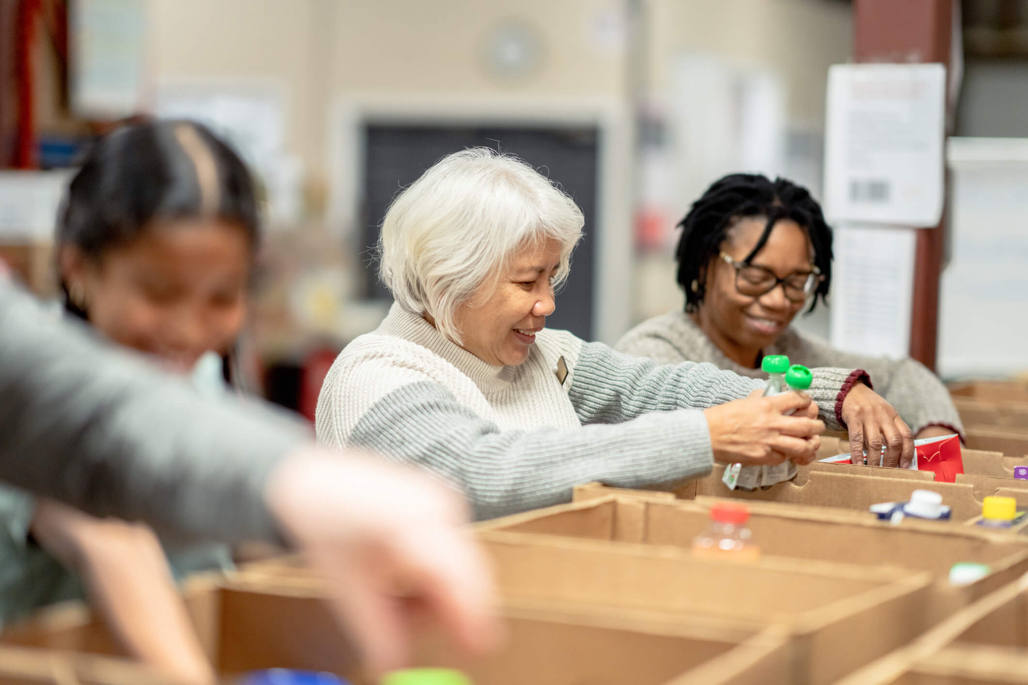 volunteers putting food items in boxes